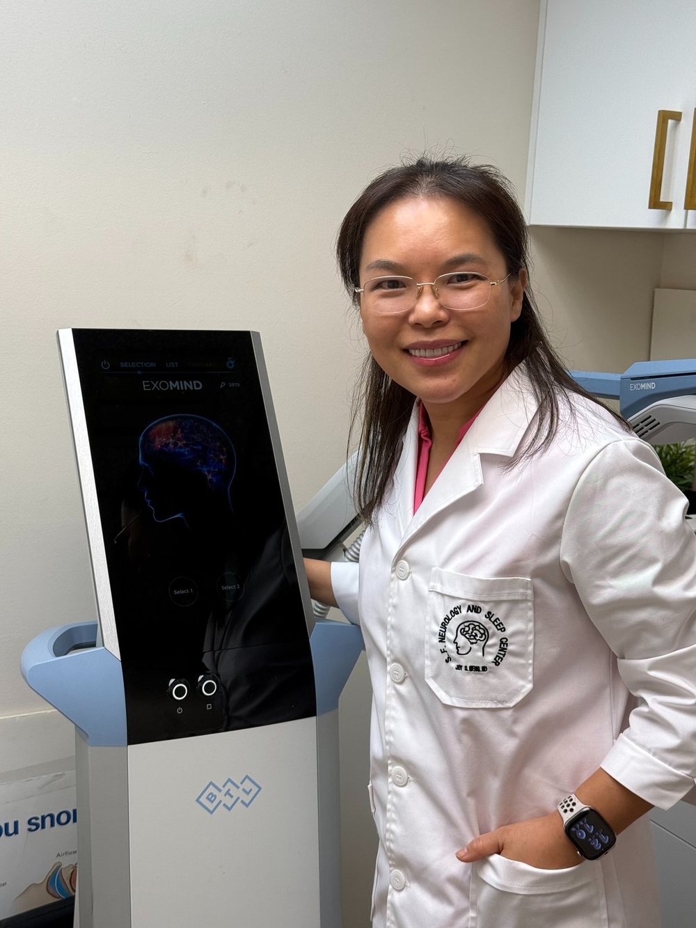 Dr. Joy Meng in the clinic beside the S5 skin analyzer