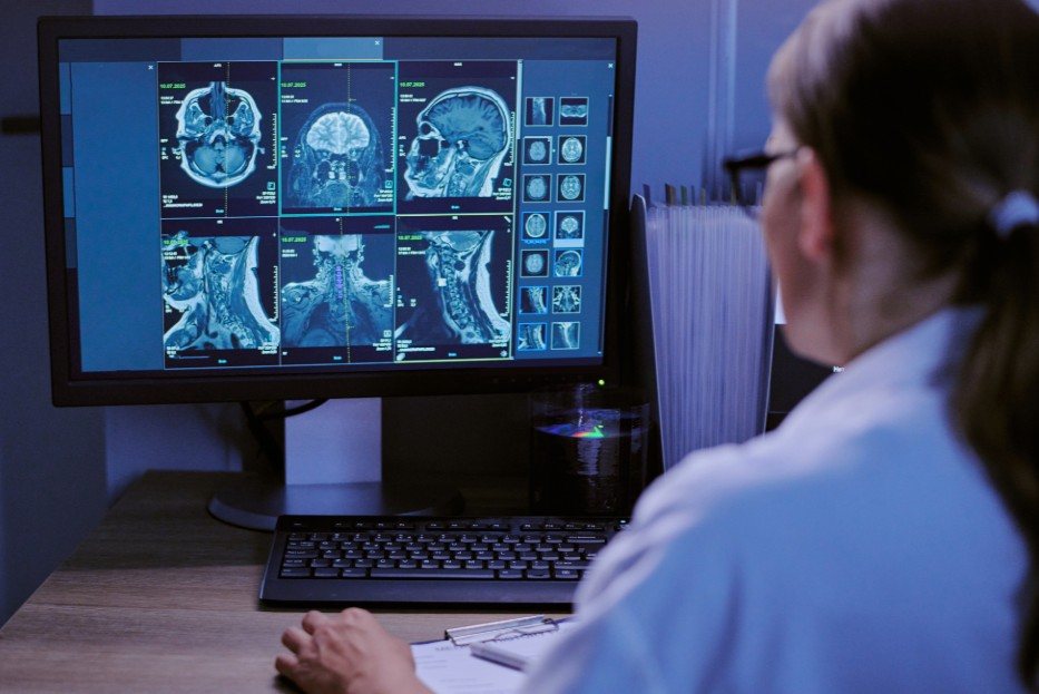 A physician reviewing brain imaging on screen